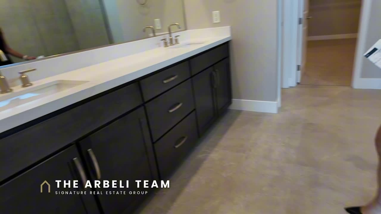 Primary bath with double vanity and medicine cabinets in the Colonial at Ashland at Summerlin, a new construction home with two primary suites