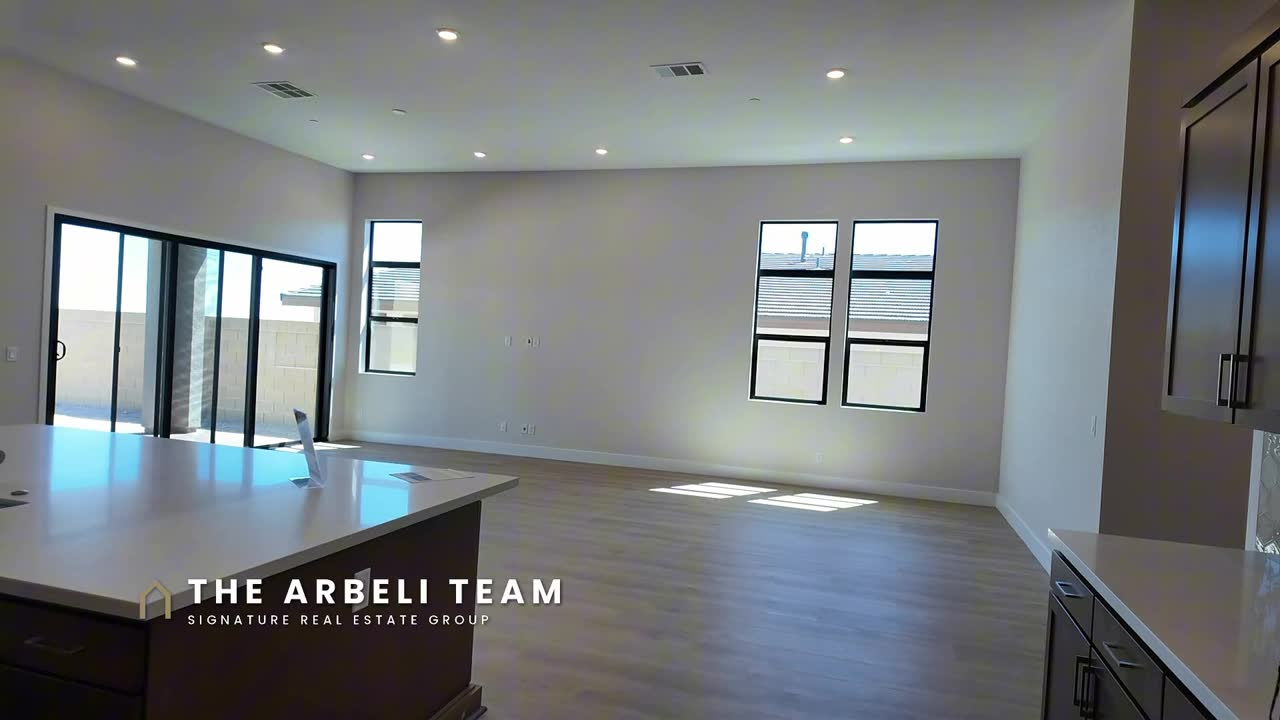 Great room with black-trimmed windows and sliders to the patio in the Frontier at Ashland at Summerlin