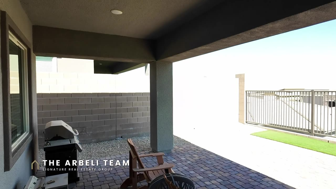 Covered paver patio with view fencing and mountain views at a 55+ single story home in Summerlin West