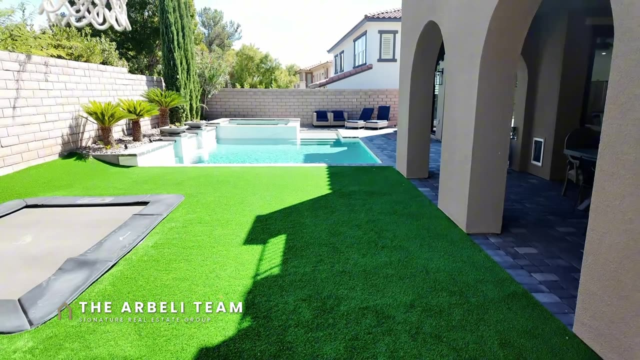 Back yard with artificial turf, in-ground trampoline, and pavers, Summerlin West home tour