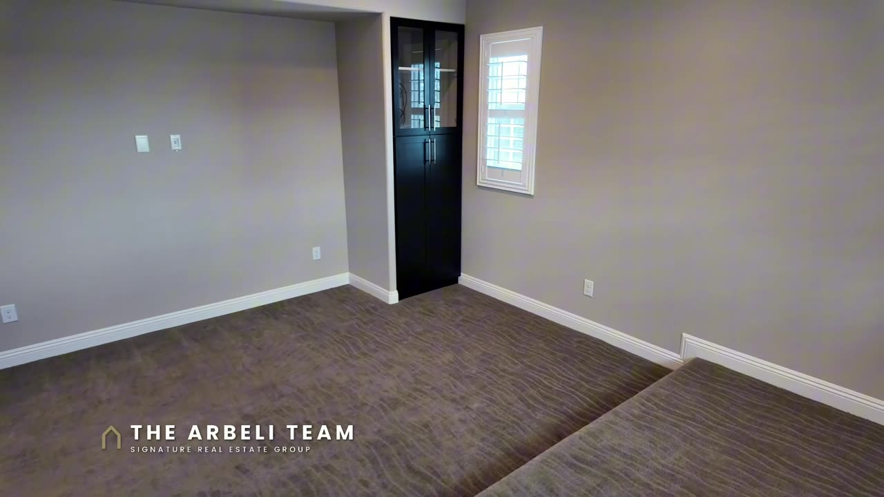 Dedicated theater room with stepped seating and built-in entertainment center in a Summerlin West home