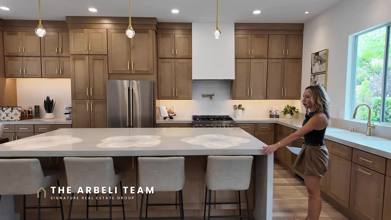 Renovated kitchen with oversized quartz waterfall island in a Summerlin single story home