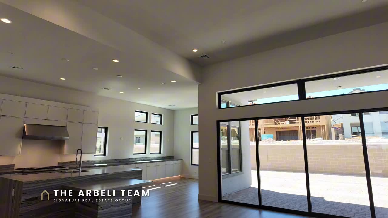 Open great room with wall of glass to the covered patio in a move-in ready single story Summerlin home