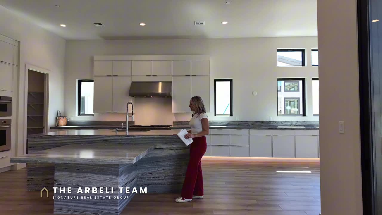 Kitchen with Wolf appliances and stacked cabinets in a single story move in ready home in Summerlin 89138