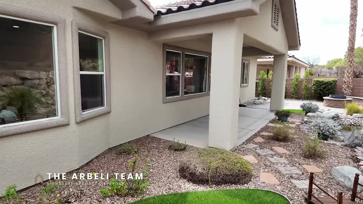 Finished backyard with waterfall pond and covered patio at a Summerlin single story home