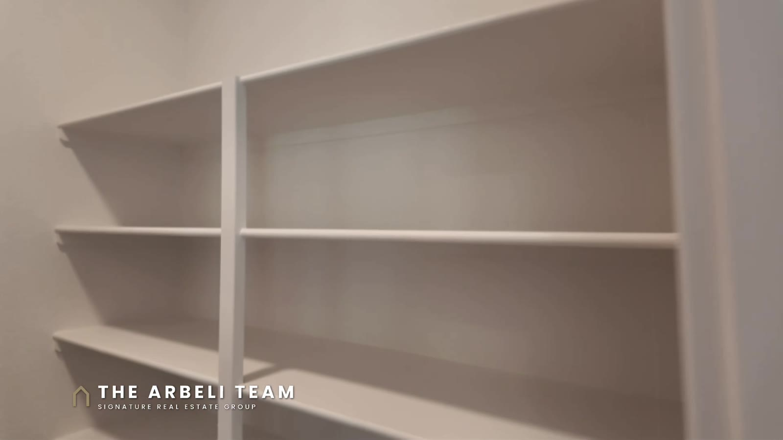 Walk-in pantry with shelving on both sides in a move-in ready Tri Pointe home at Aberdeen Collection II, Las Vegas
