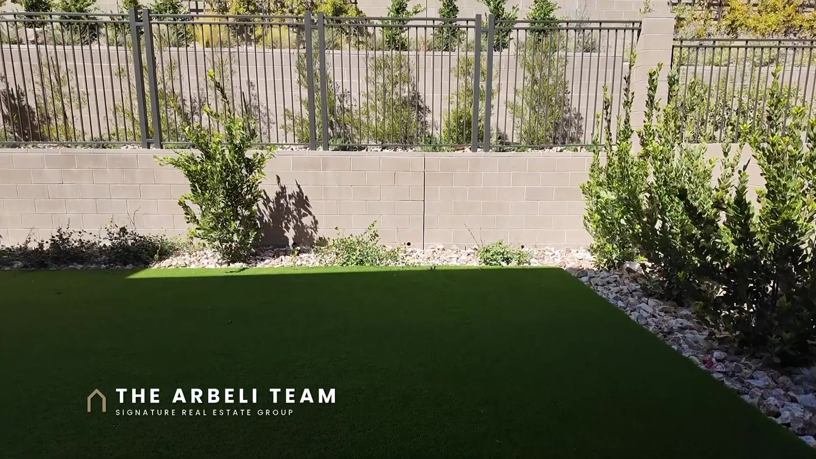 Finished back yard with artificial turf and landscaping at a move-in ready Tri Pointe home in Carlisle Peak, Summerlin West