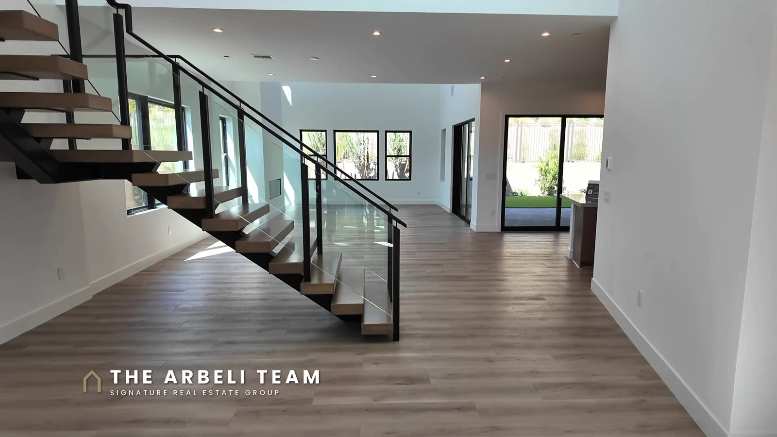 Floating stairs and high ceilings in the entry of a move-in ready Tri Pointe Plan 3 at Carlisle Peak, Grand Park, Summerlin West