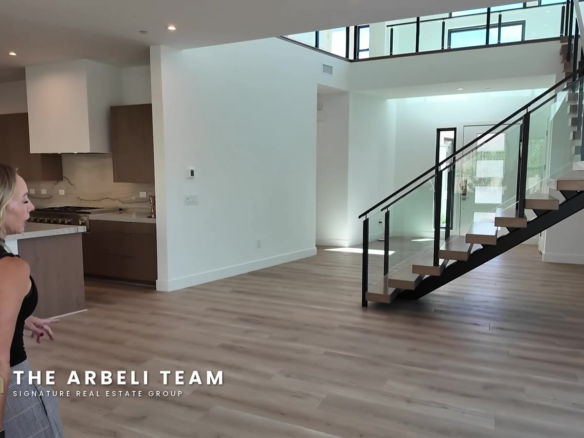 Open great room, kitchen and floating staircase in a move-in ready Carlisle Peak home in Grand Park, Summerlin West