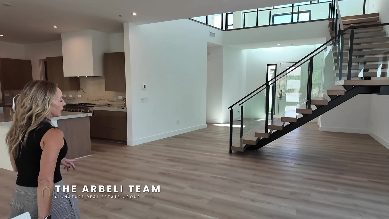 Open great room, kitchen and floating staircase in a move-in ready Carlisle Peak home in Grand Park, Summerlin West