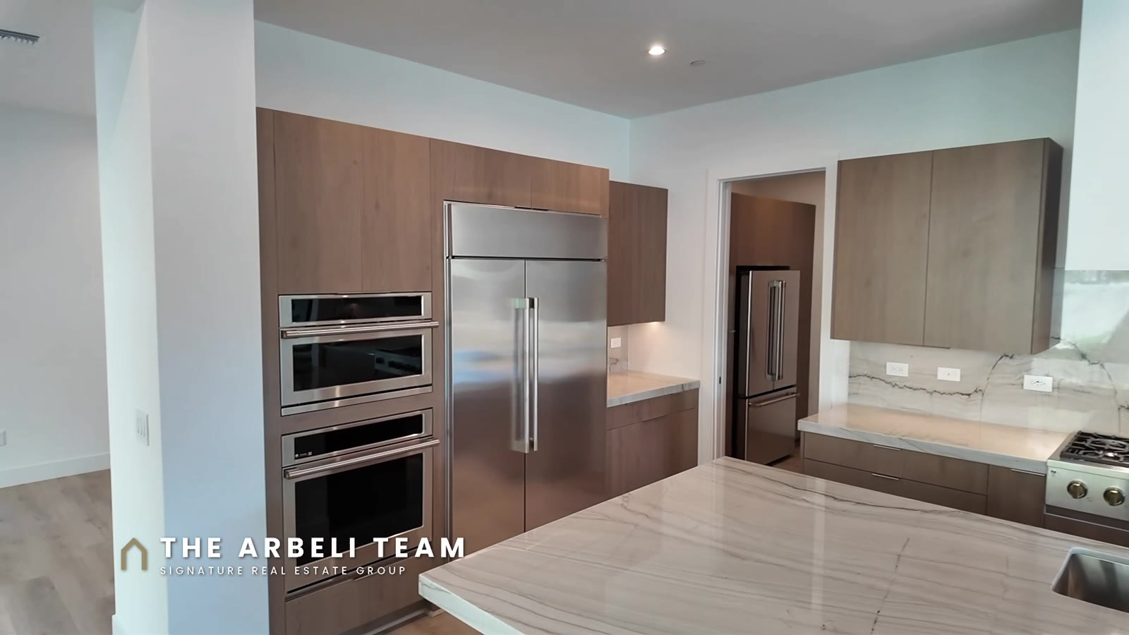 GE Monogram appliances and wood cabinetry in the kitchen of a Tri Pointe Plan 3 at Carlisle Peak, Summerlin West 89138