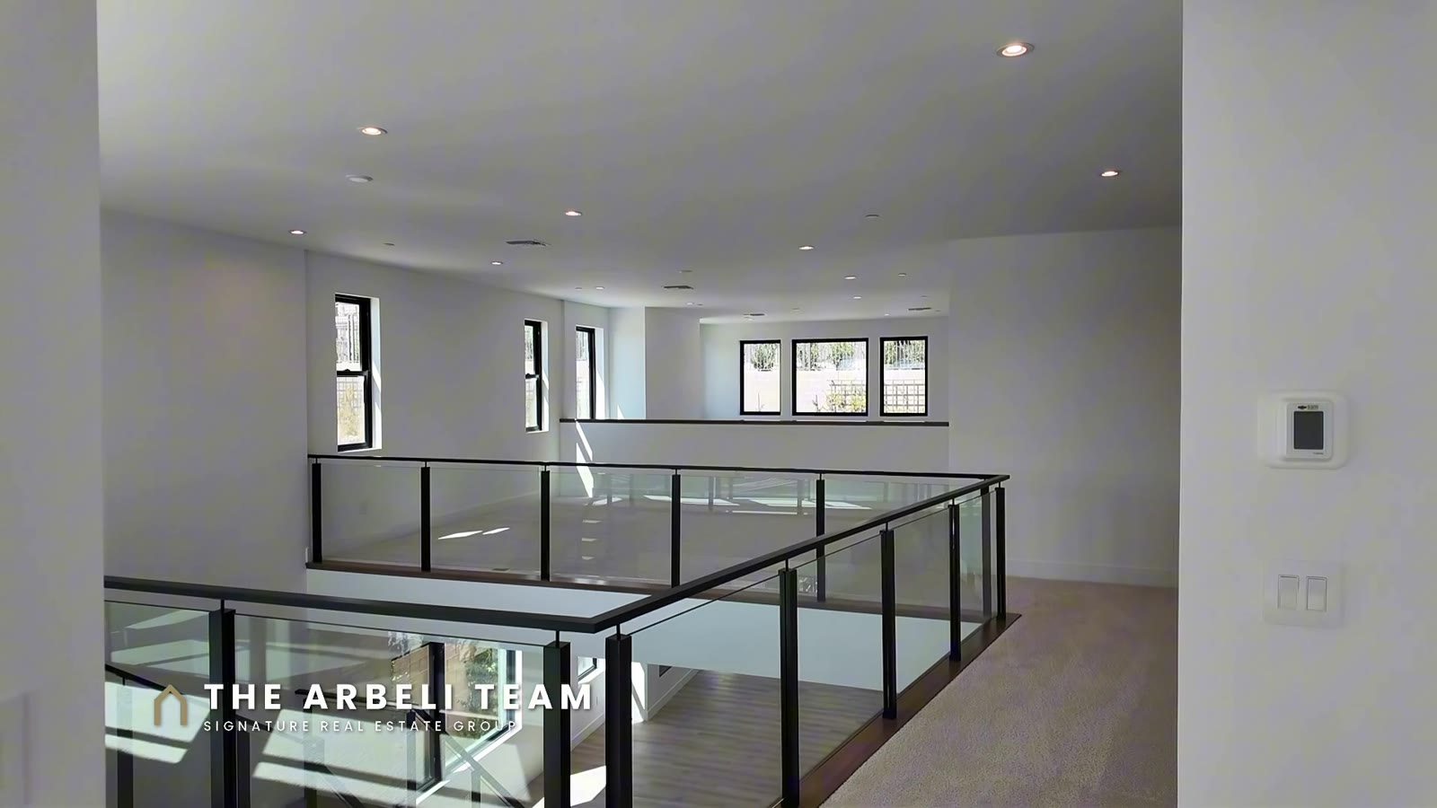 Upstairs loft with glass railing overlooking the great room in a Tri Pointe Plan 3 at Carlisle Peak, Las Vegas 89138