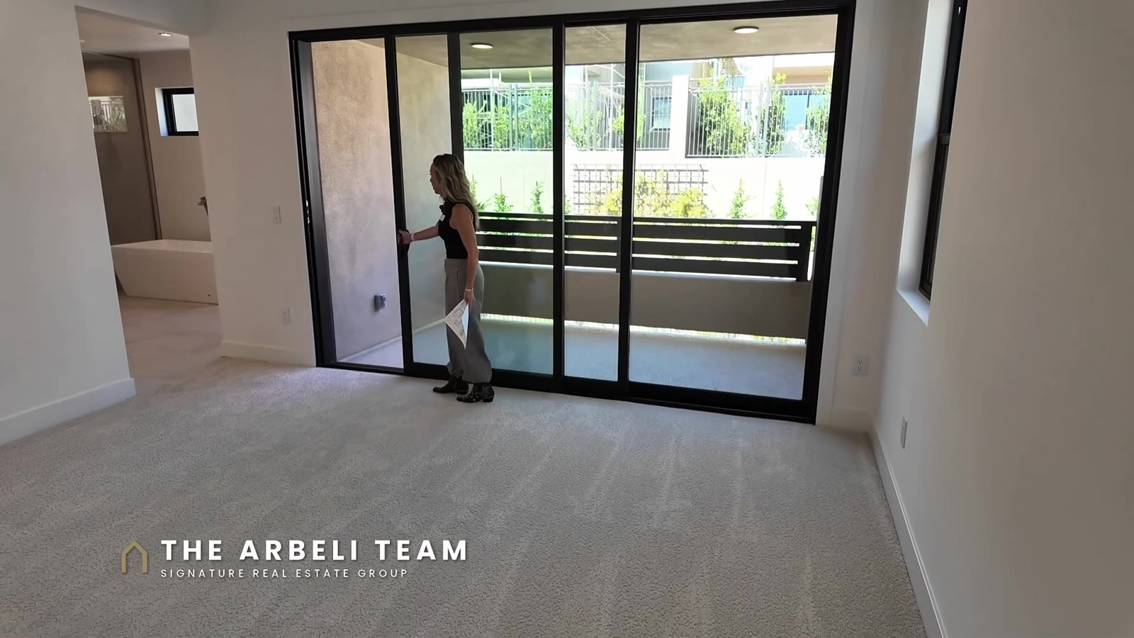 Primary suite with a three-panel slider to a private balcony at Carlisle Peak in Grand Park, Summerlin West